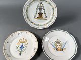 three plates with designs on them are sitting on a table