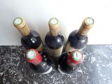 several bottles of wine are lined up on a counter top