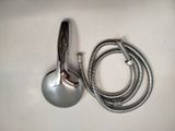 a shower head and a shower hose on the counter