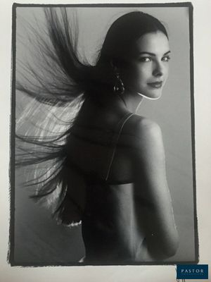 black and white photograph of a woman with long hair blowing in the wind