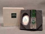 a bottle of perfume in a box next to a box