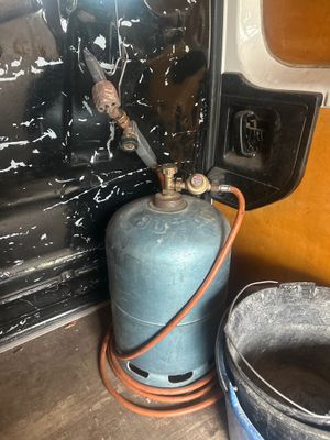 a propanent and a bucket of water in the back of a truck