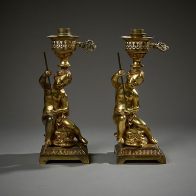 pair of antique brass candlesticks with figures on stands