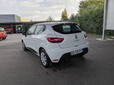the rear end of a white car parked in a parking lot
