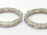 pair of silver and gold hoop earrings on white background