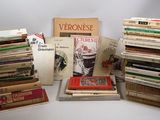 several books are stacked on top of each other on a table