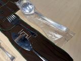 a picture of a knife, fork, spoon and spoon rest on a table