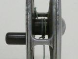 an old fishing reel on a white surface