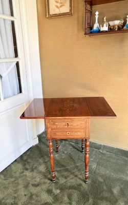 une petite table avec un tiroir dans le coin d'une pièce