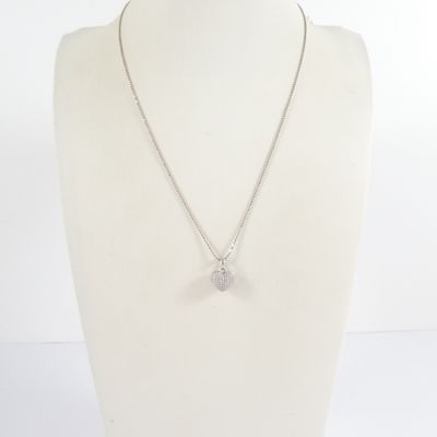 a white mannequin with a silver necklace on a white mannequin
