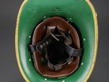 an old green and brown helmet with a leather band