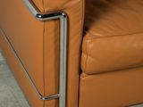 a brown leather chair with a metal frame