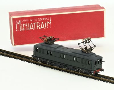 a toy train that is on the tracks next to a box