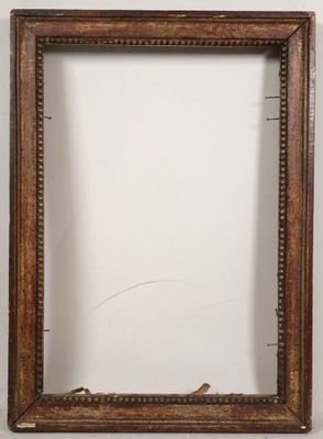 an old wooden picture frame with a white wall in the background