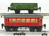 a red and green train car sitting on the tracks