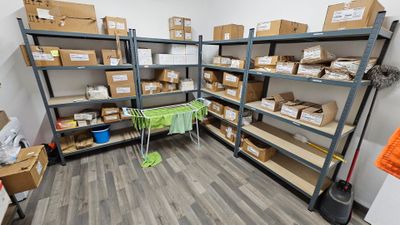 une pièce remplie de cartons, avec d'autres cartons sur les étagères