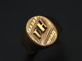 a close up of a gold ring on a black surface