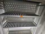 an open refrigerator with a lot of shelves in it