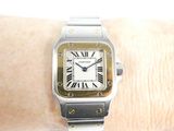 a silver and gold wrist watch on a woman ' s wrist