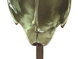brass sculpture of a human head on a black marble base