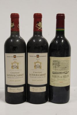 three bottles of red wine sitting next to each other on a white surface