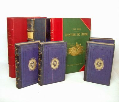 four books are lined up in a row on a white surface