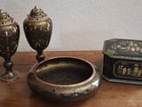 two vases and a box sitting on a table
