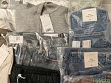 many different types of clothing on display in a store