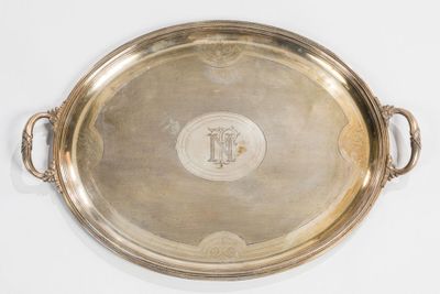 a large silver tray with handles on a white surface