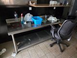 an image of a kitchen with a table and a chair