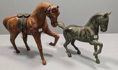 two figurines of horses that are standing next to each other