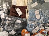 many different types of clothing on display in the store