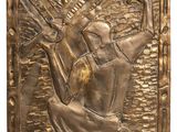 an image of a bronze plaque depicting a woman holding a fan