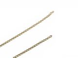 two pieces of gold chain on a white surface with a white background