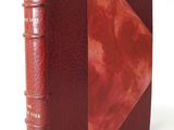 an old book with a red leather cover and a red leather binding