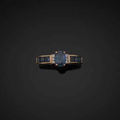 a blue sapphire and diamond ring on a black background