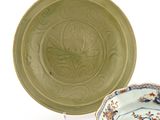 two plates and a bowl sitting on a white surface