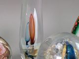 three glass vases with different colored rocks in them sitting on a table