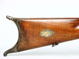 an old rifle with a wooden barrel and brass plated handle