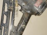 a nail gun that is sitting on the floor