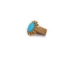 a close up of a gold ring with a turquoise stone