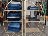 a rack with jeans on it in a store