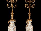pair of antique brass candelabs with blue and white floral designs