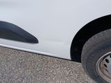 a close up of a white car with a flat tire