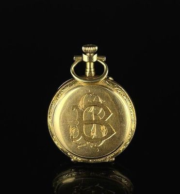 an image of a gold pocket watch sitting on top of a black surface