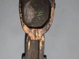 a close up of a wooden object on a gray surface
