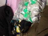 a pile of clothes and other items on a bed
