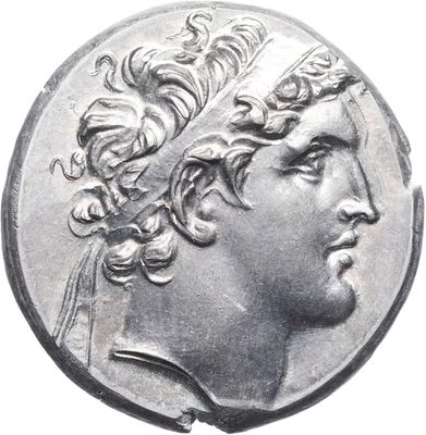 a close up of a silver coin with a man ' s head on it
