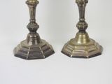 pair of antique brass candlesticks on a white background