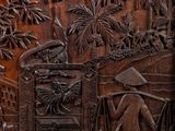 an old wooden door with carvings of people and trees on it